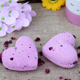 ylang ylang and rose heart shaped bath bombs with real rose petals in.